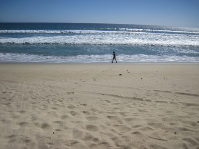 Monica walking on the beach.