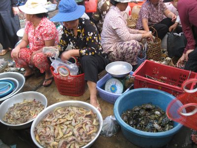 Women selling seafood at the wet market in the Kampot market.