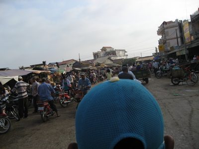 View from the back of a motorbike approaching the market...