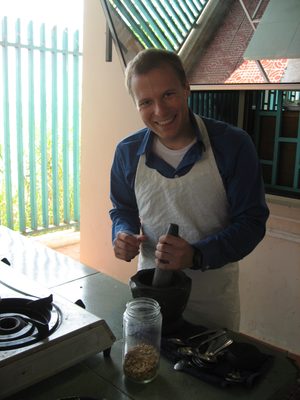 John, grinding peanuts into paste for spring rolls.