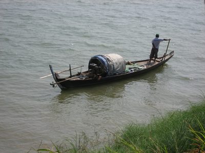 A fisherman rowing his way by our cooking class on the...