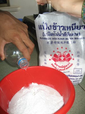 Glutenous rice flour (in the bag) being mixed with water.