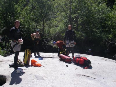 Putting on wet suits and getting ready to jump in the river