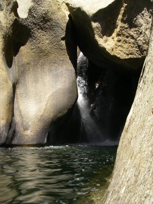 Someone rappelling through a waterfall. 