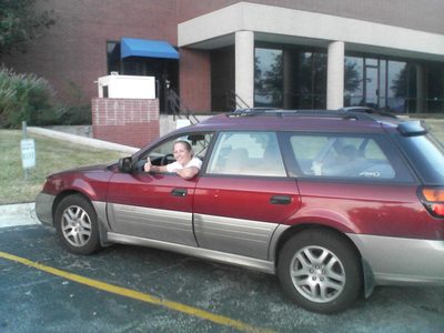 Catherine in Lumberg's parking spot.