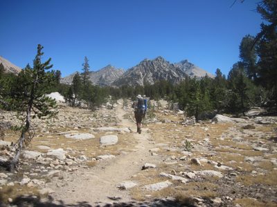 Joel, trekking across a meadow where we cross the John...