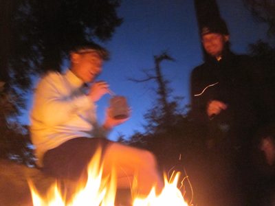 Eating dinner around our campfire.