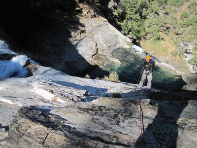 Yang, rappelling into the shade.