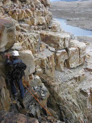 Rodrigo setting up a rope to rappel off the cliff.  More...