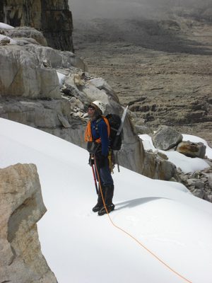 Close up of Rodrigo inspecting the cliff band for a good...