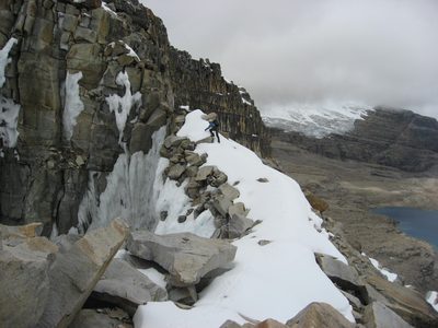 Rodrigo climbs along a knife edge ridge with very...