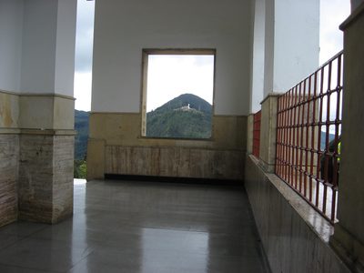 Outside the church, framing the statue on the far mountain.