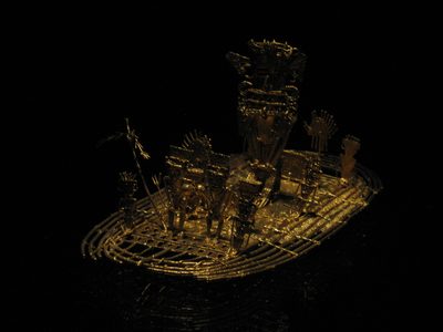 Very impressive solid gold boat with shaman and other...