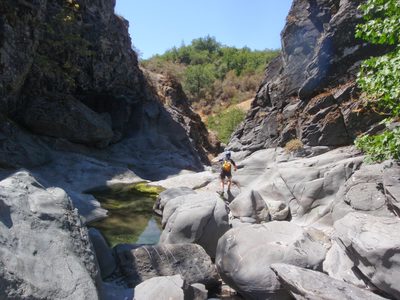 Monica hops across some boulders.