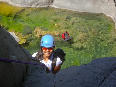 Christina pausing to smile on rappel.