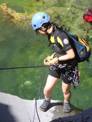 Monica going over the final lip of the first rappel.