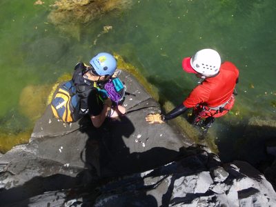 John helps Monica stow the rope after the first rappel.