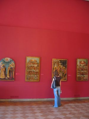 Alison studying some artwork.