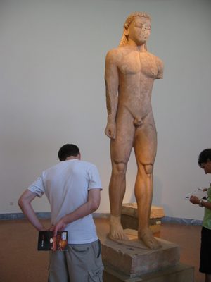 Nick studying a statue of a kouros, or boy.