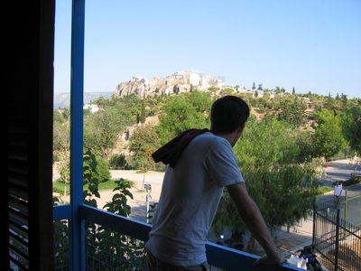 Nick peering over the railing of our balcony of our...