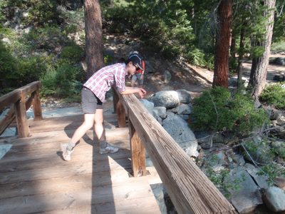 Monica, relaxing on the bridge over Return Creek.