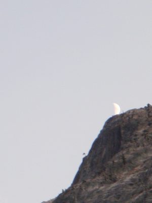 Moon, setting behind the south wall of the canyon, above...