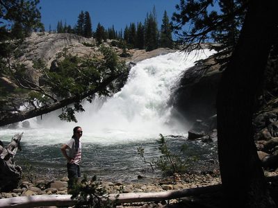 Rachel in front of the Tuolumne river near the flooded...