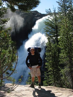John standing in front of a waterfall on the upper...