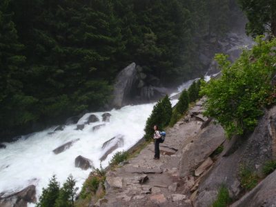 Monica stands by the mighty Merced River as it races by....