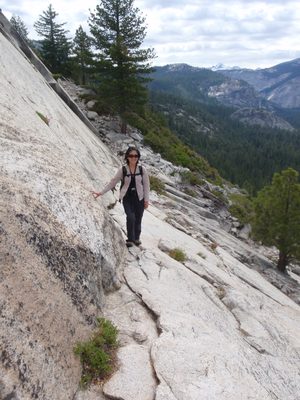 Monica tiptoeing carefully across the exposed ledge.