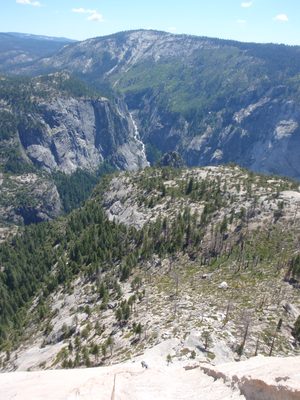 Monica climbing Snake Dike, with Illilouette Falls in...