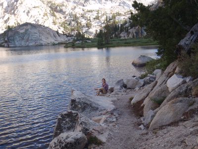 Monica washing her swollen feet by the lake.
