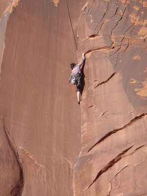 Monica, grabbing for a rare jug in Indian Creek.