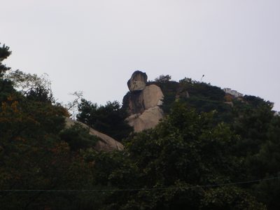 A rock that is supposed to look like a seated Buddha. ...