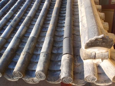 The clay tiles that cover the wooden roof.