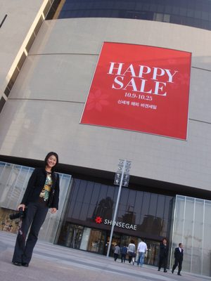 Monica outside Shinsegae: HAPPY SALE.  Whatever,...