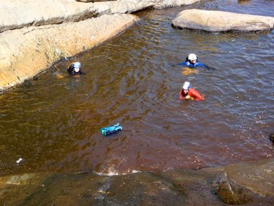 Monica, Catherine and Joel swim in the muddy brown water.