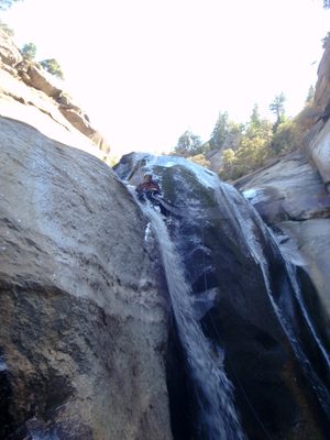 Joel rappel-sliding down the 170 footer.