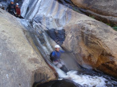 Catherine races down a water slide below the last...