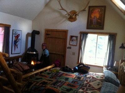After a long ski in, Monica warms her hands by our...