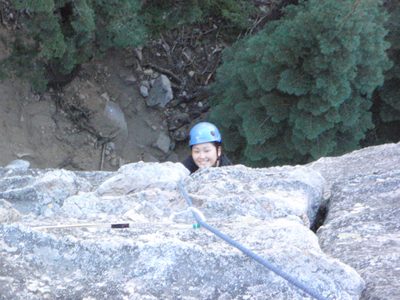 Monica, climbing the first pitch of Surrealistic Pillar (5.7).