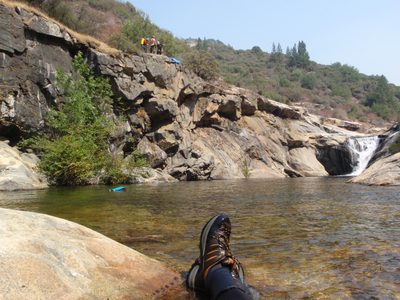 Relaxing in the river while waiting for others to rappel down.