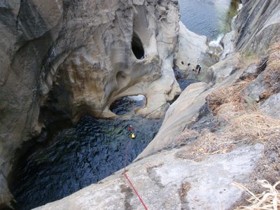 Joel swimming for shore, to begin the second part of the rappel.