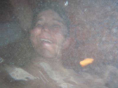 Monica's face distorted by the surface of the water. ...