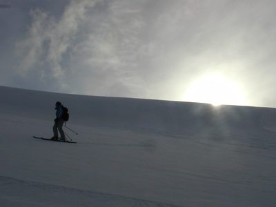 Rachel, inspecting her tracks as the sun sets behind the...