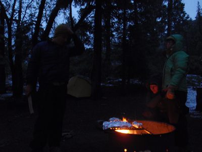 Jon grilling potatoes in aluminum foil and Sydney trying...