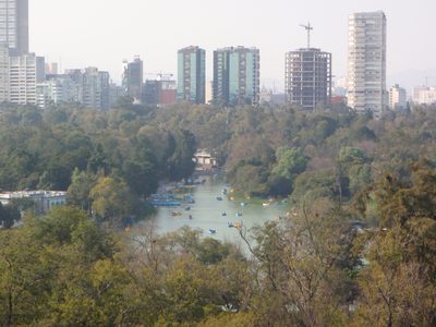 A lake in Chapultepec park and new high rises going up near by.