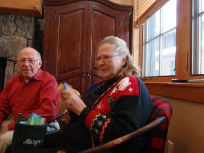 Mom opening a present while Dad looks on.