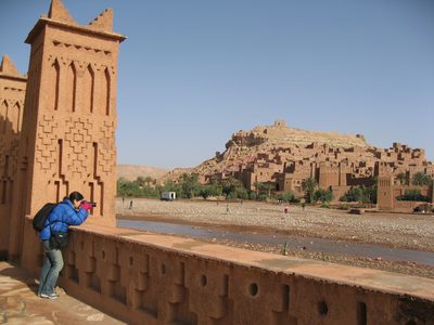 Heidi taking a photo with the Ait Bennadou Casbah in the...