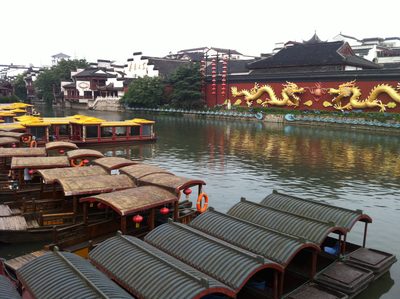 River boats and wall with Chinese dragons.